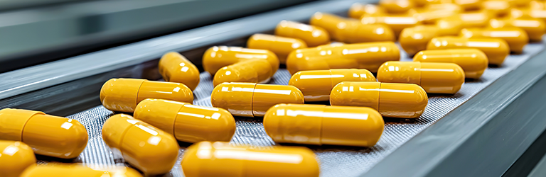 Capsules in conveyor belt